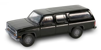 GREEN28150-D - CHEVROLET Suburban C10 custom deluxe 1985 schwarz aus der Serie BLACK BANDIT unter Blisterverpackung.